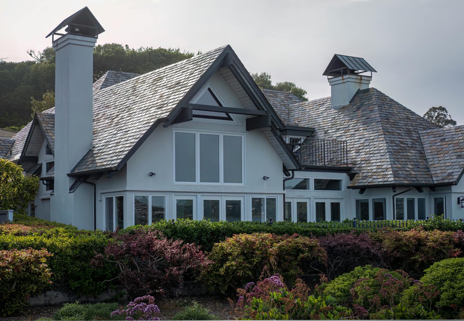 A beautiful luxury villa surrounded by a vibrant garden showcasing exquisite design and elegance.